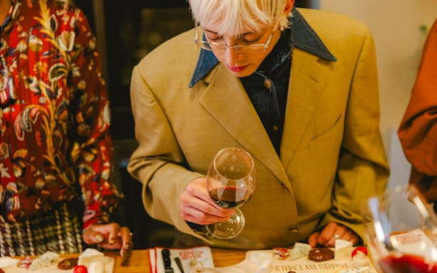 Couple tasting cheese and wine on Emily in Paris tour, Paris, France.