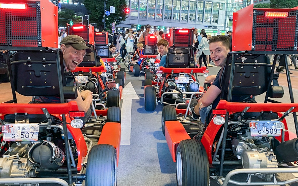 Go-kart riders on Shibuya street tour in Tokyo, Japan.