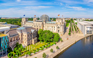 Aerial view of the Reichstag building and Spree River in Berlin during summer.