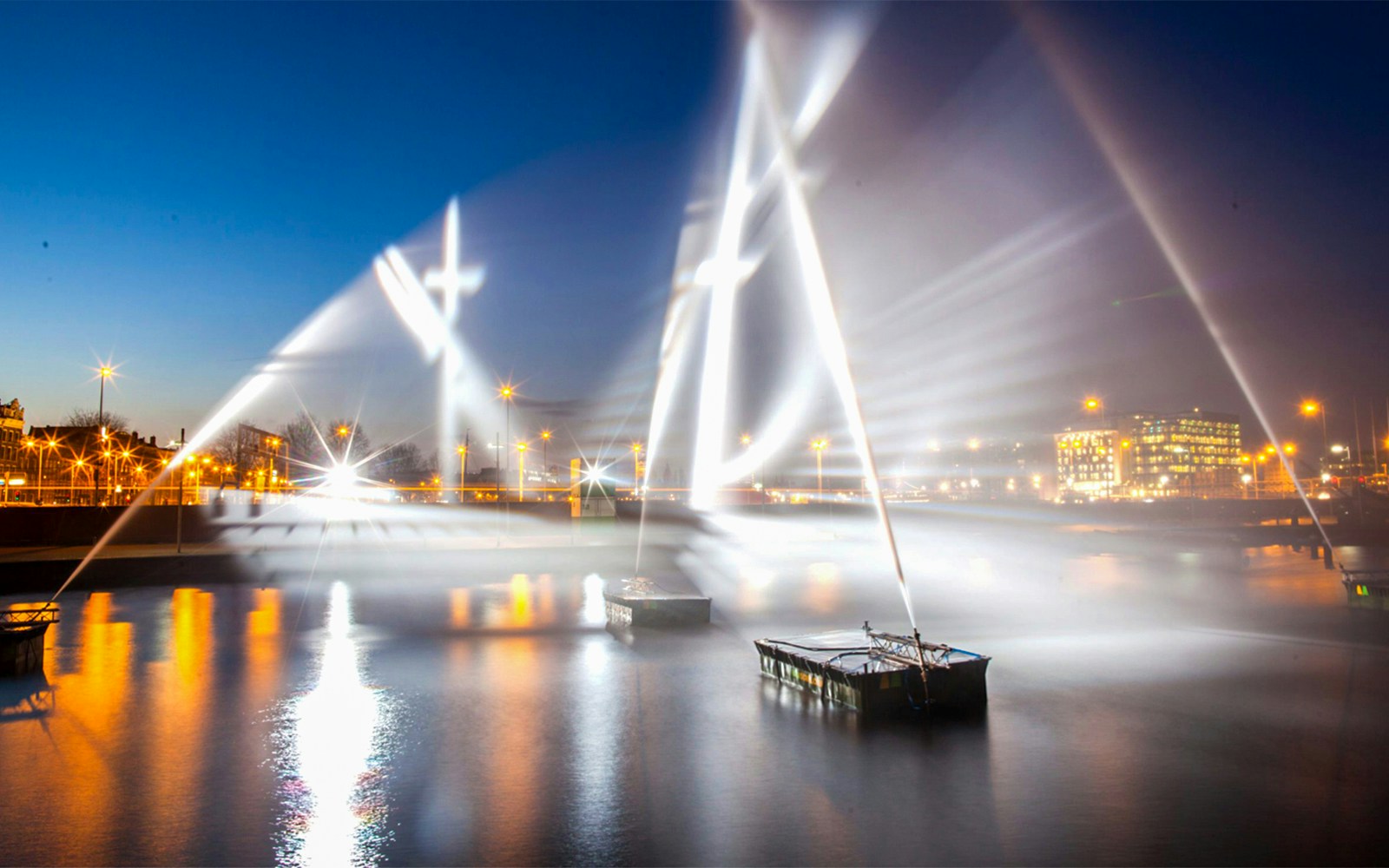 Amsterdam Light Festival installations illuminating the canal at night.