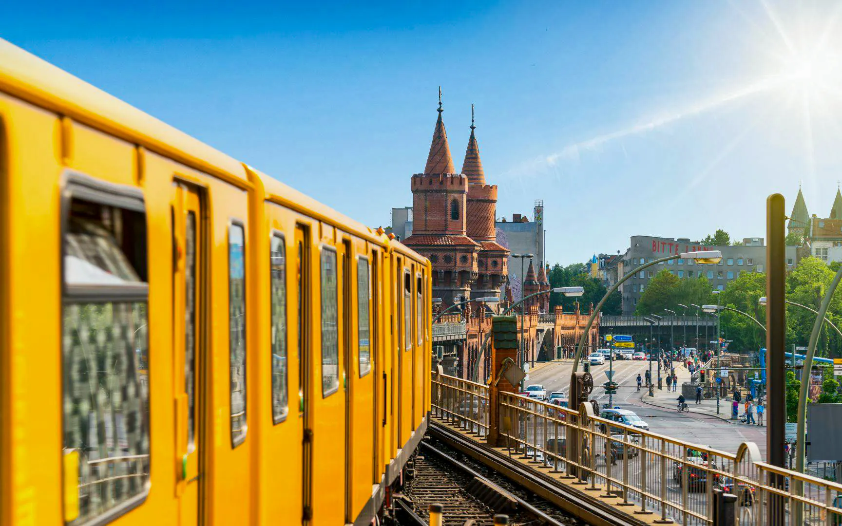 Yellow U-Bahn train crossing Oberbaumbrücke bridge over the Spree River in Berlin, Germany.