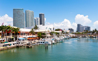 Bayside Marketplace marina with boats and Miami skyline in the background.