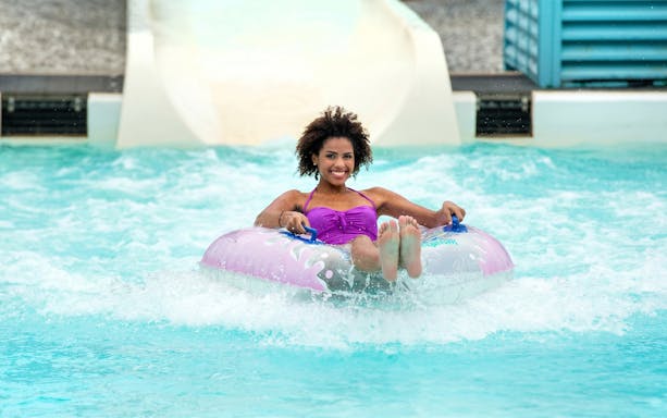 Person enjoying a water slide at Lightning Falls, Dorney Park.