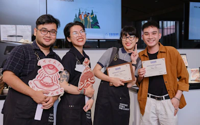 Participants holding certificates at a Vietnamese coffee workshop in Hồ Chí Minh City.