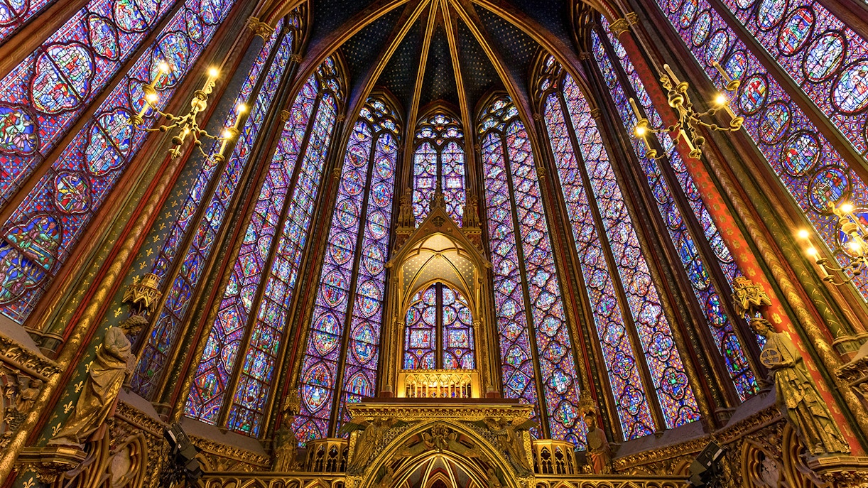 Stained glass windows inside Sainte Chapelle, Paris, showcasing biblical scenes.
