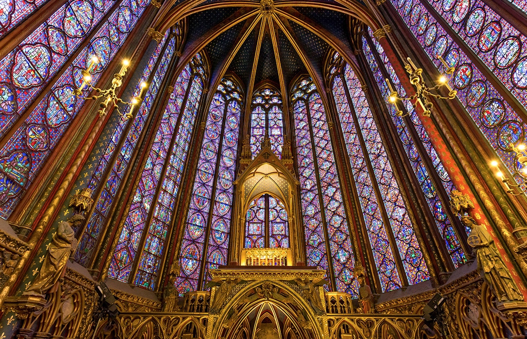 Stained glass windows in Upper Chapel of Sainte Chapelle, Paris, showcasing biblical scenes.