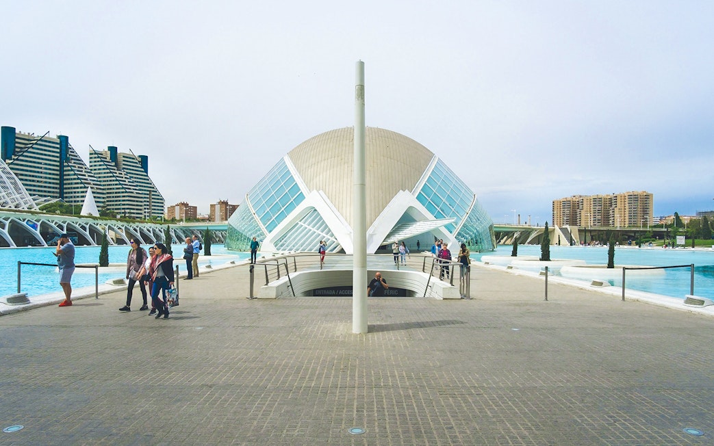 Hemisfèric building with visitors at City of Arts and Sciences, Valencia.
