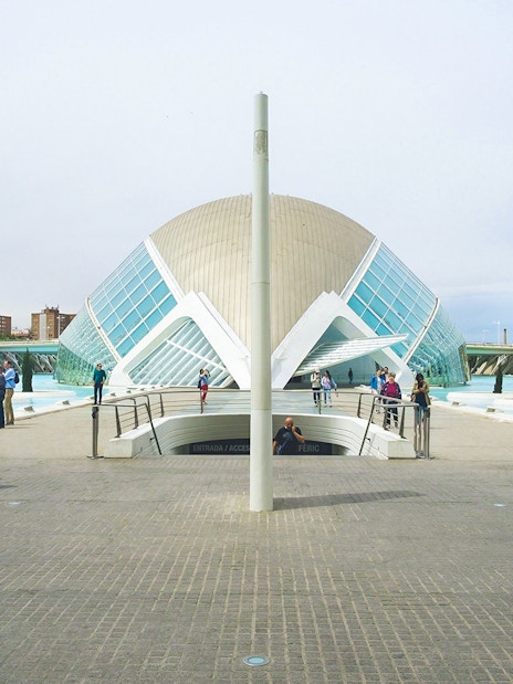 Hemisfèric building with visitors at City of Arts and Sciences, Valencia.