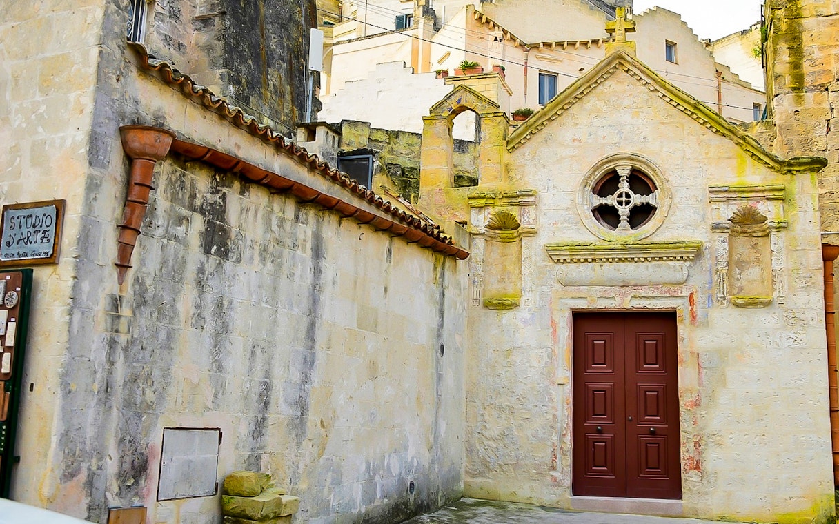 Facade of historic building in Sassi of Matera during guided tour.