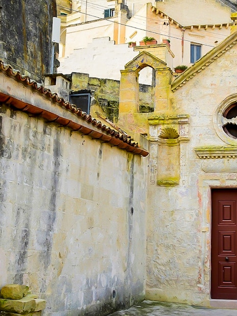 Facade of historic building in Sassi of Matera during guided tour.