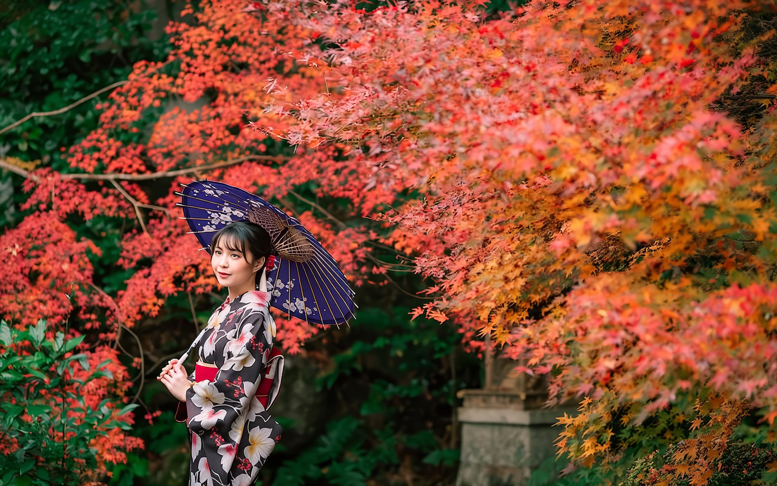 Lady in kimono with umbrella amidst vibrant autumn leaves in Japan.