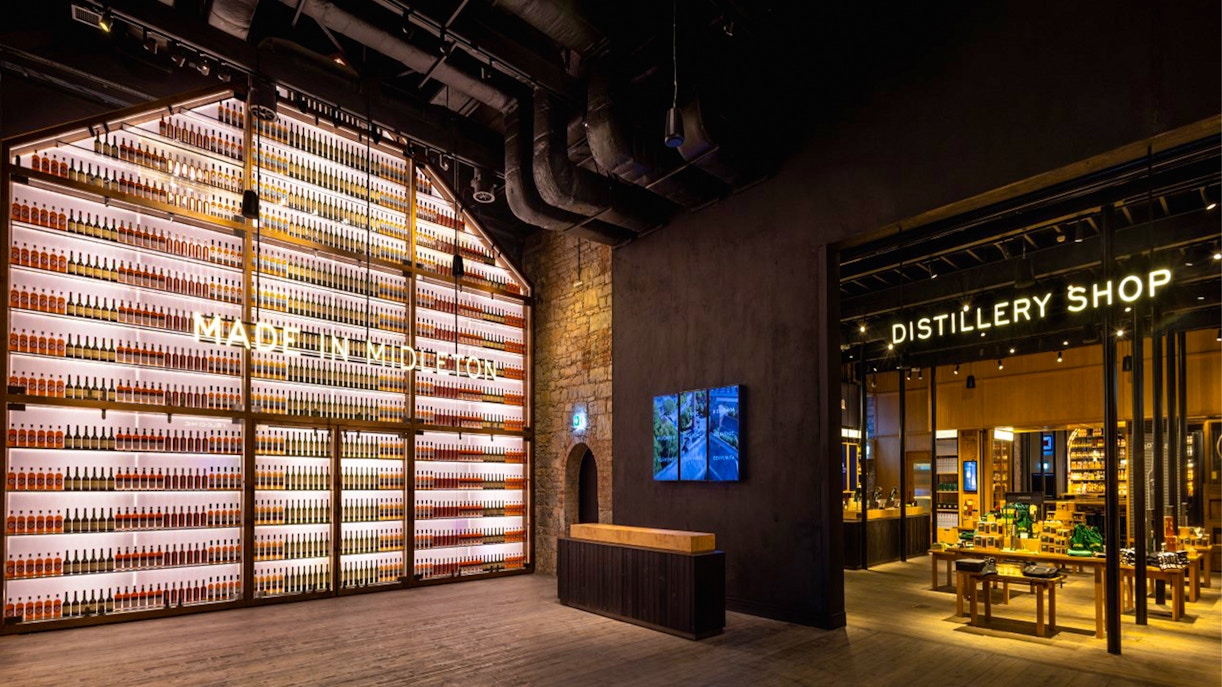 Midleton Distillery tour guide explaining whiskey production process with copper stills in view.