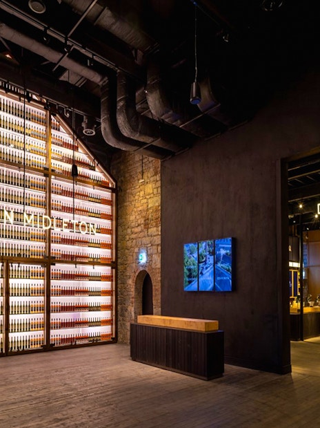 Midleton Distillery interior with bottle display and distillery shop entrance.