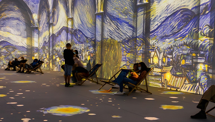 Guests viewing Van Gogh projections at London exhibition.