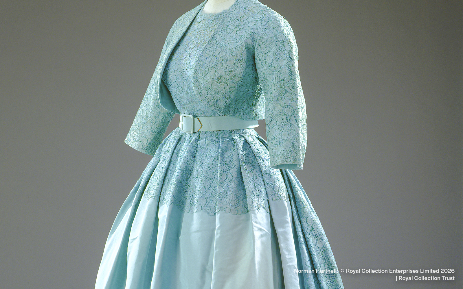 Ensemble designed by Norman Hartnell for Princess Margaret's wedding, featuring lace and satin.