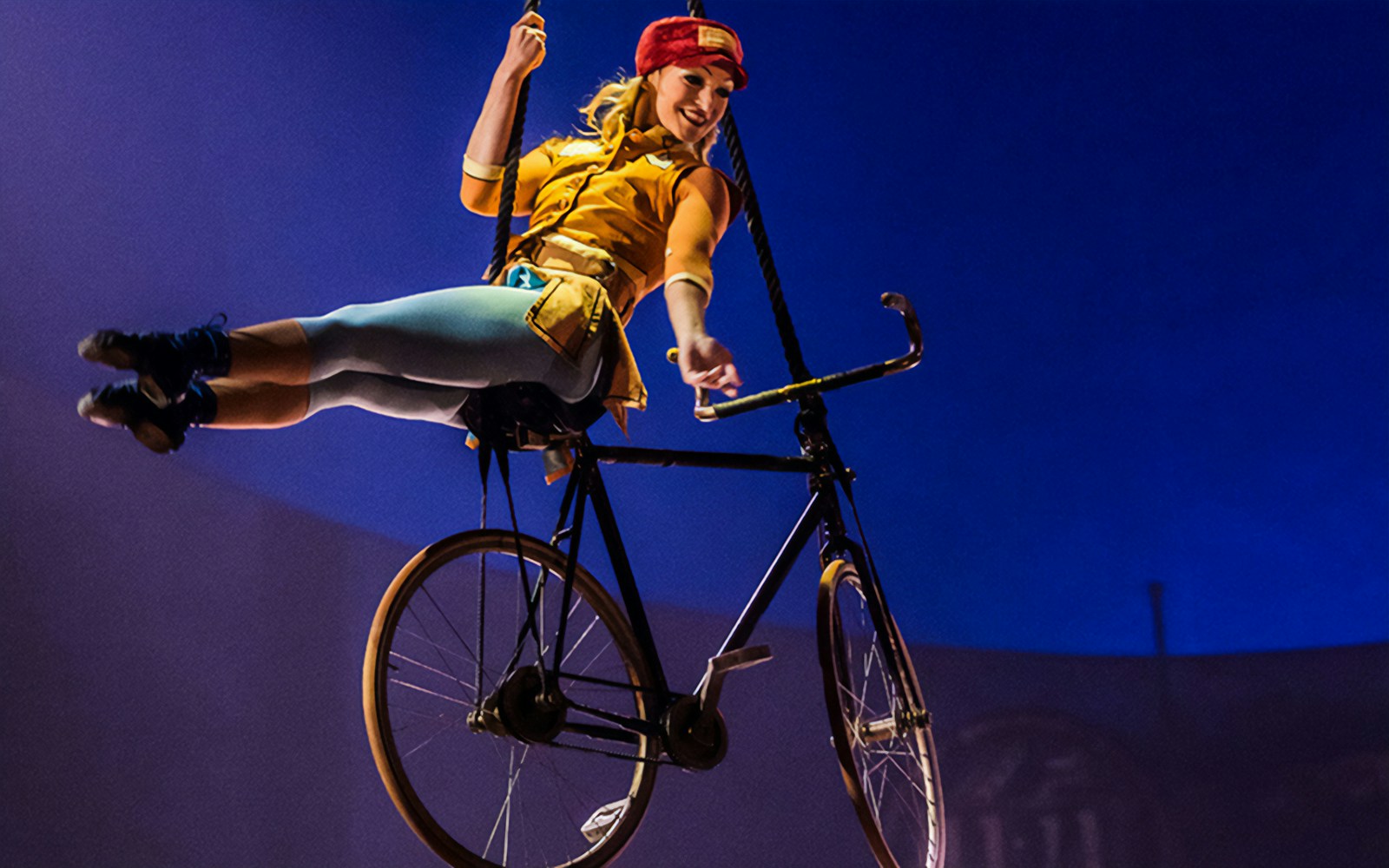 Performer on a suspended bicycle at Cirque du Soleil: Kurios show.