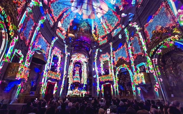 Colorful light projections inside Clérigos Church during Spiritus event, Porto.