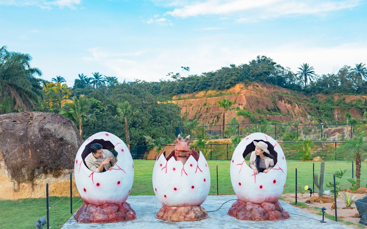 Dinosaur eggs with people and a dinosaur emerging, Dino Desert attraction.