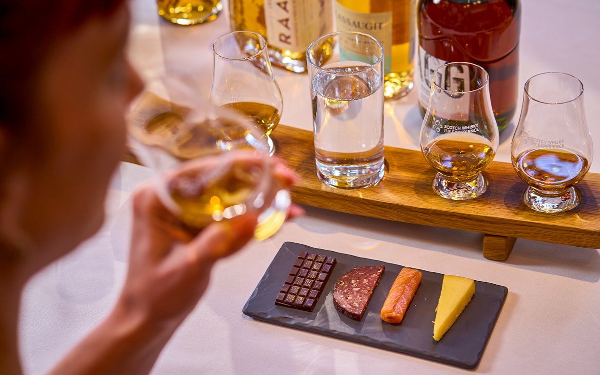 Whiskey tasting with chocolate, salami, salmon, and cheese pairing.
