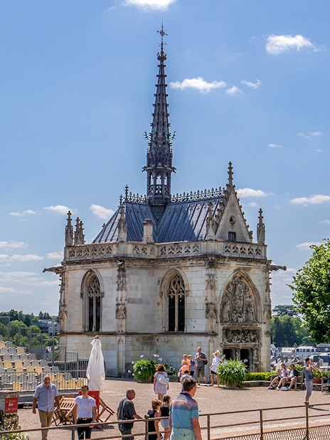 Royal Amboise Castle chapel with visitors and seating area in the foreground.