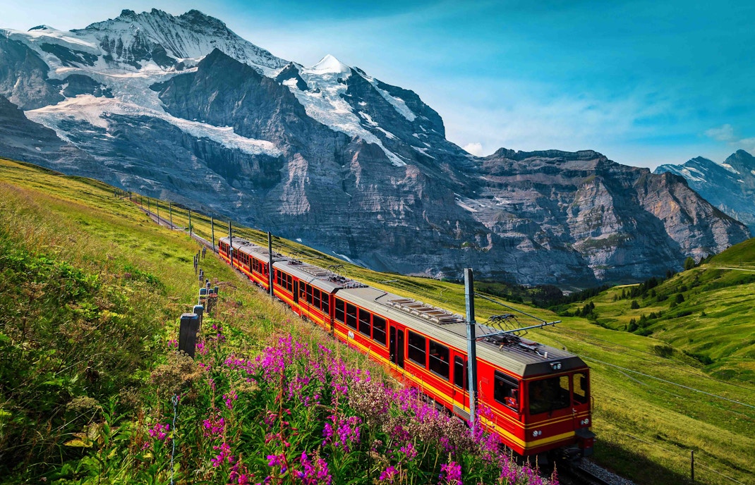 Train Crossing with Mountain Background.