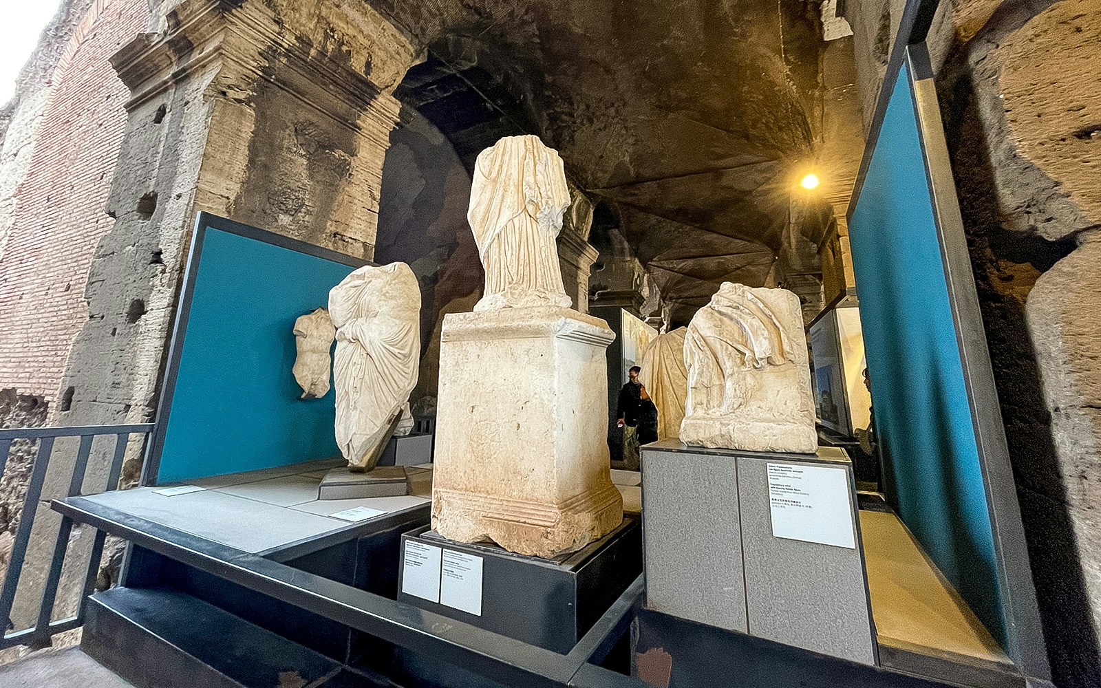 Ancient Roman statues displayed inside the Colosseum Museum in Rome.