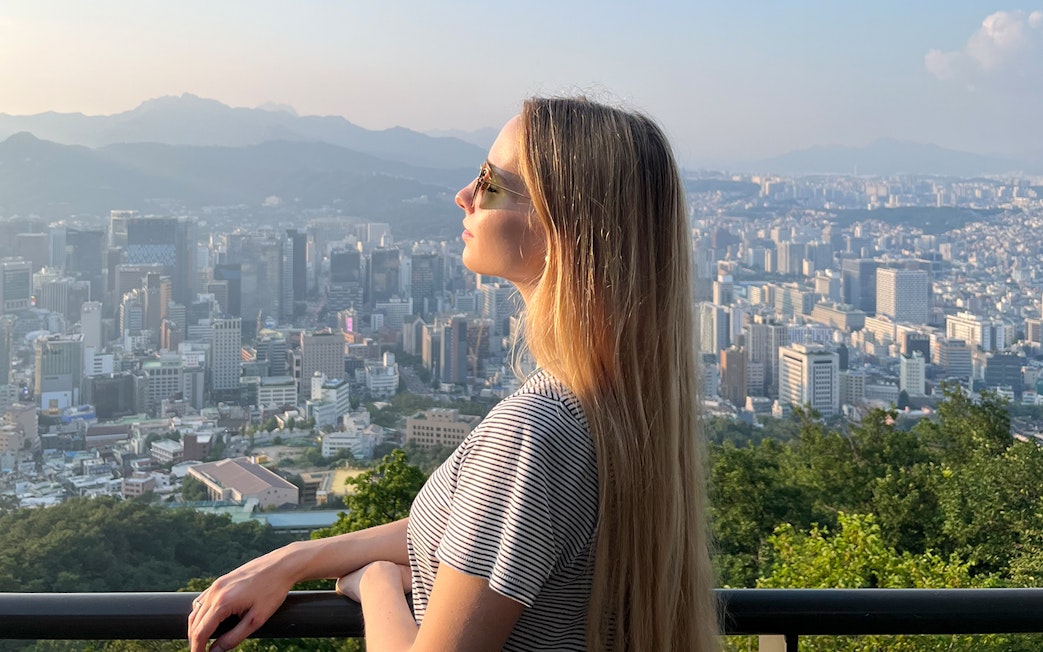 Person enjoying Seoul cityscape view from N Seoul Tower.