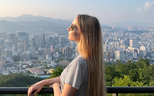 Person enjoying Seoul cityscape view from N Seoul Tower.