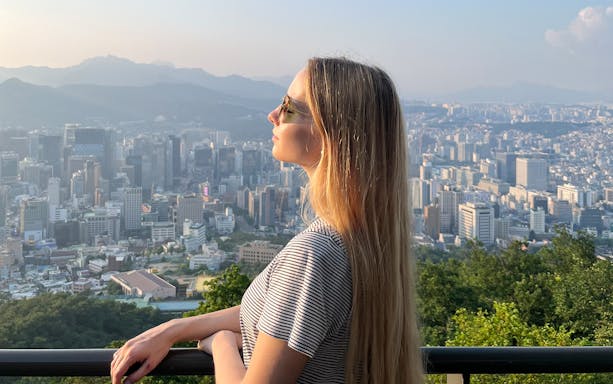 Person enjoying Seoul cityscape view from N Seoul Tower.