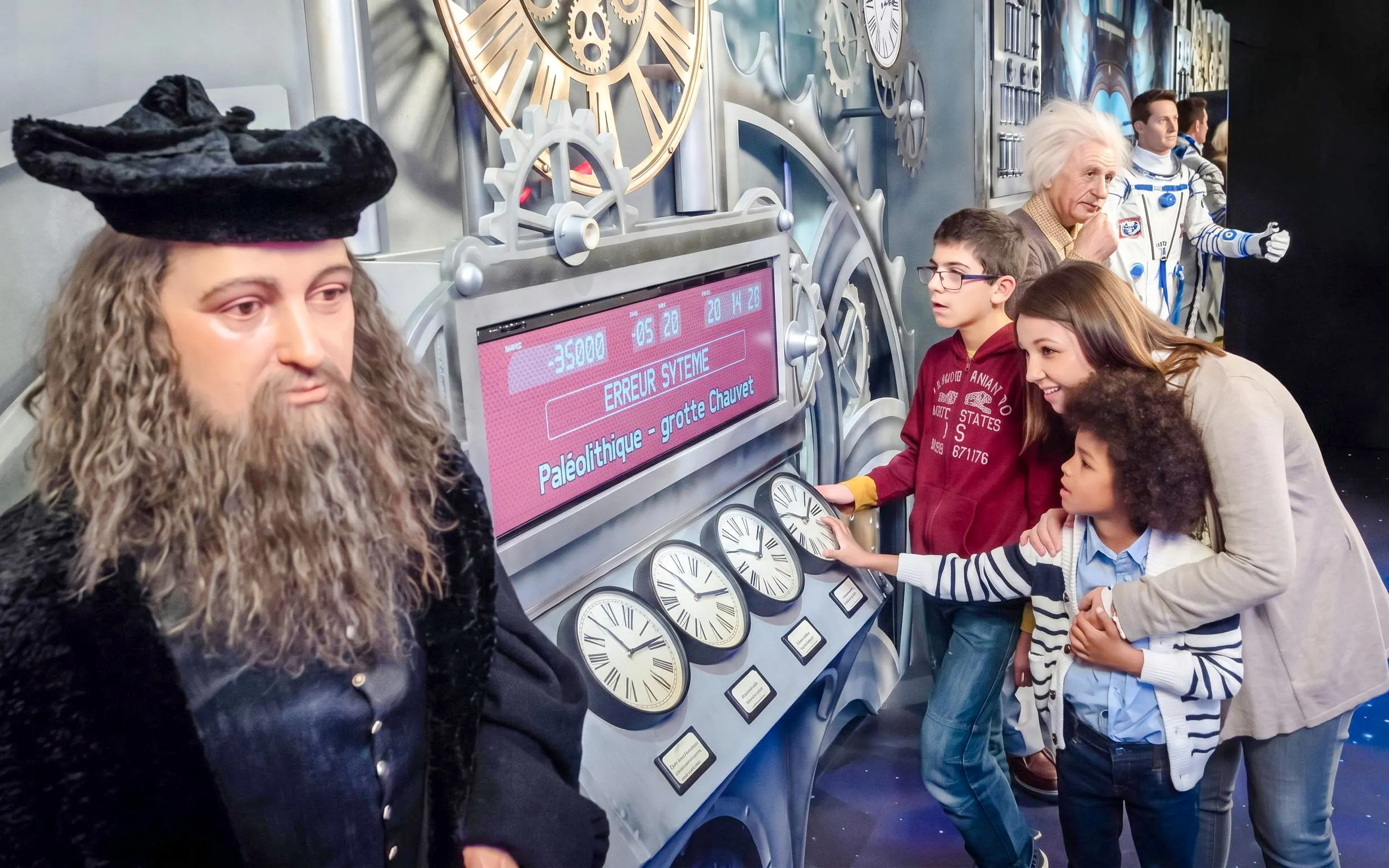 Visitors interacting with wax figures at Grévin Wax Museum, Paris.