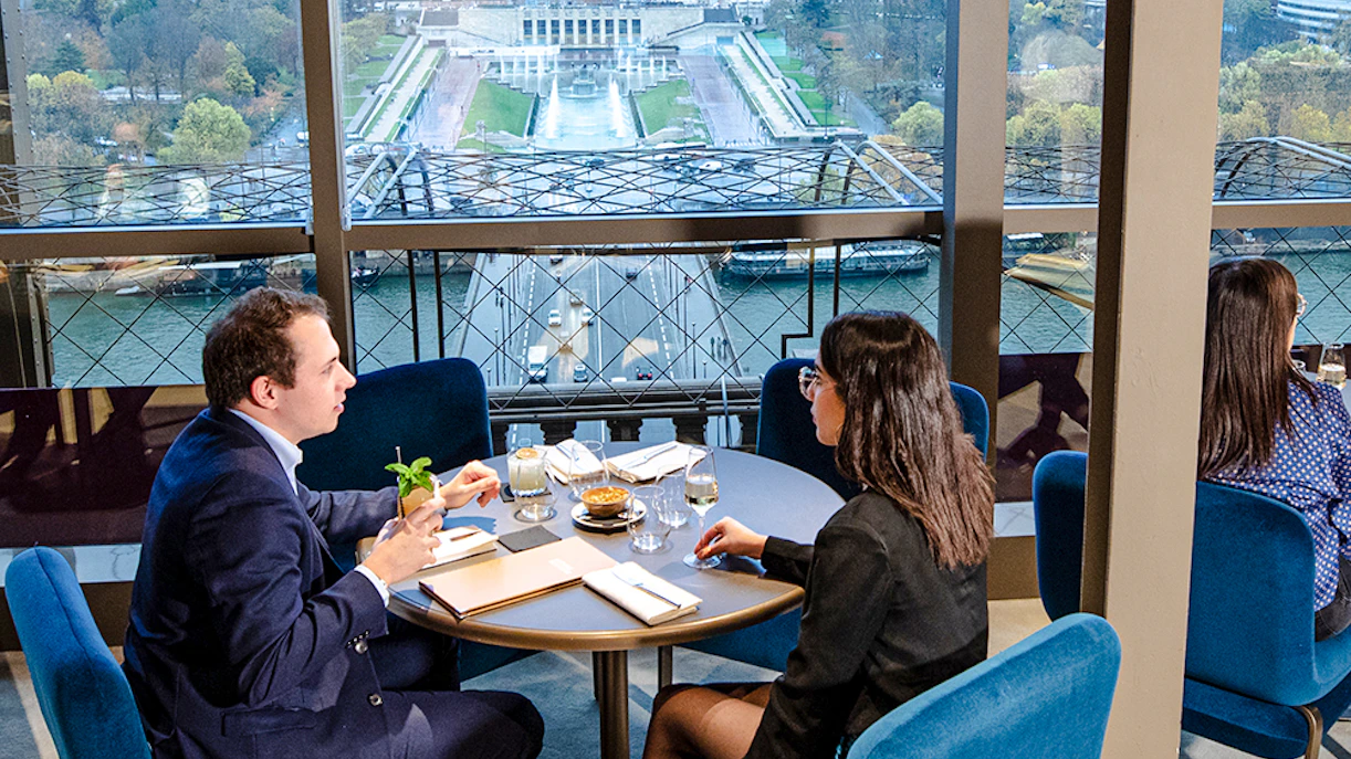 Couple dining at Madame Brasserie with view of Trocadéro Gardens, Paris.