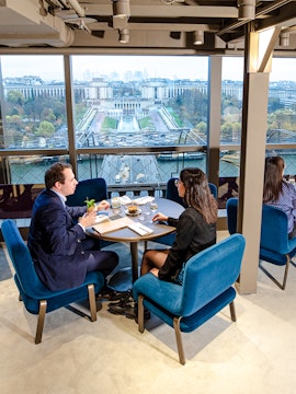 Couple dining at Madame Brasserie with view of Trocadéro Gardens, Paris.