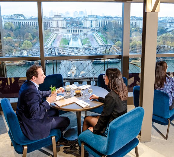 Couple dining at Madame Brasserie with view of Trocadéro Gardens, Paris.