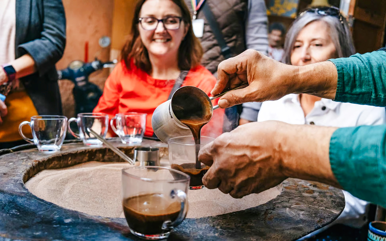 Pouring traditional Moroccan coffee during a private shopping tour in Marrakech souks.