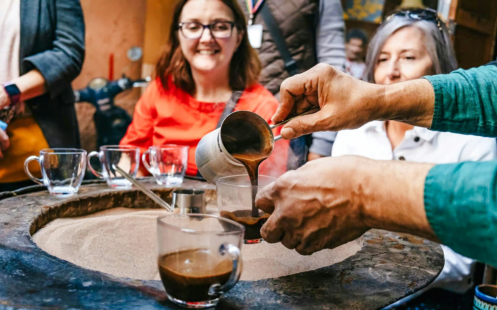 Pouring traditional Moroccan coffee during a private shopping tour in Marrakech souks.