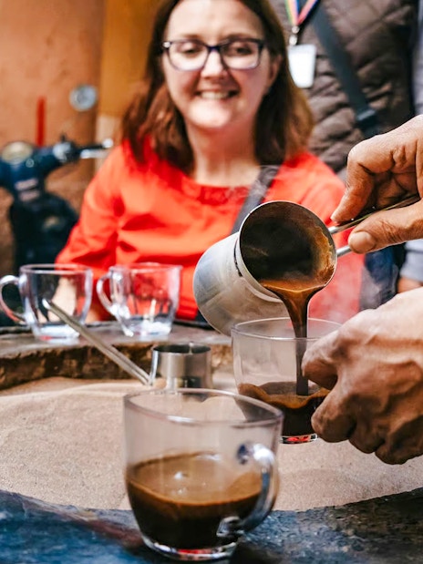 Pouring traditional Moroccan coffee during a private shopping tour in Marrakech souks.