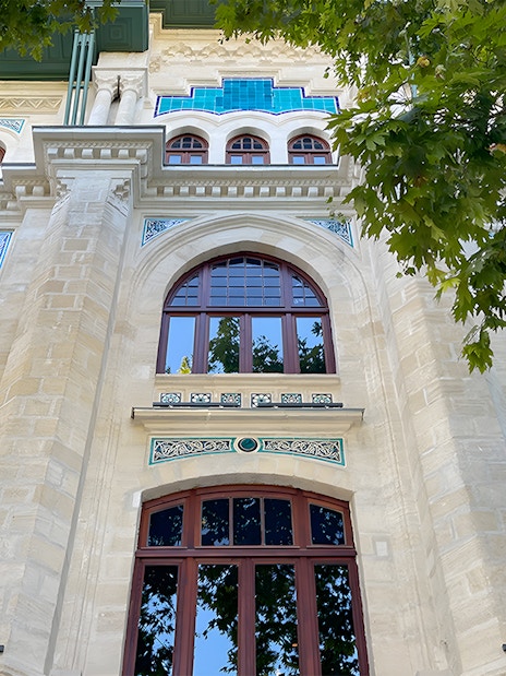 Facade of Hagia Sophia Museum with Turkish flags and intricate architectural details.