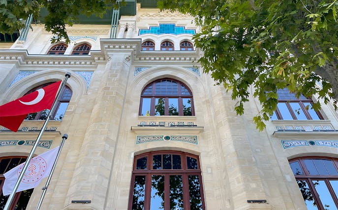 Facade of Hagia Sophia Museum with Turkish flags and intricate architectural details.