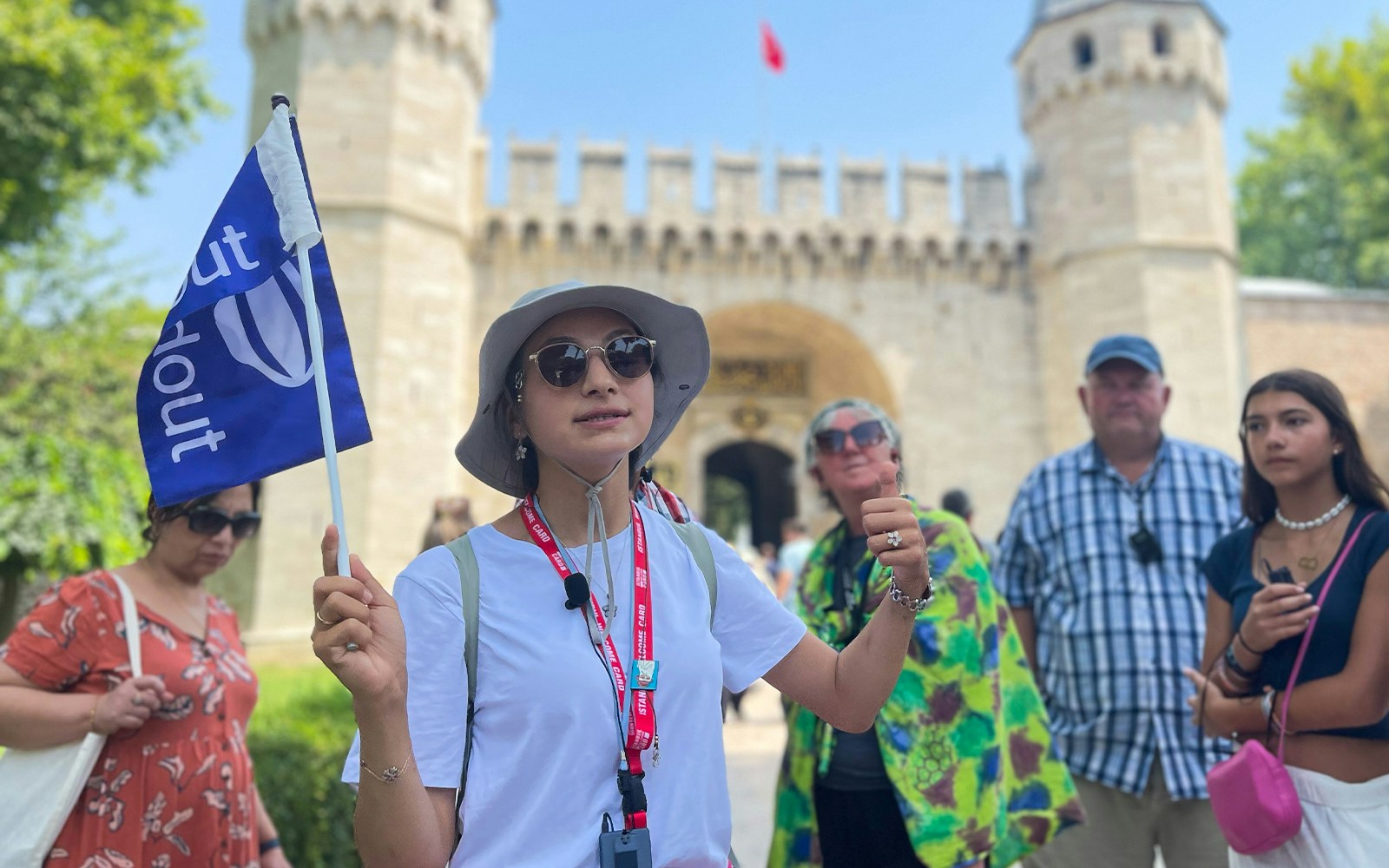 Guide leading tourist group outside Topkapi Palace entrance, Istanbul.