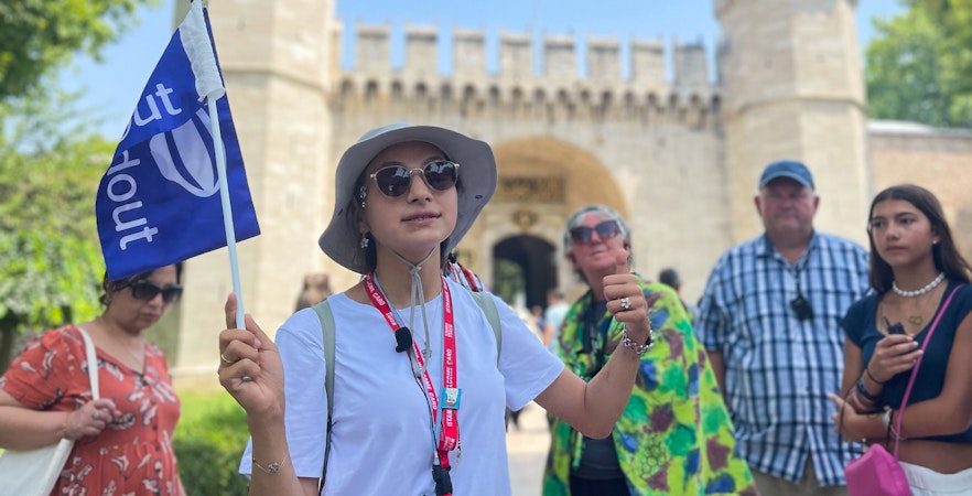 Guide leading tourist group outside Topkapi Palace entrance, Istanbul.