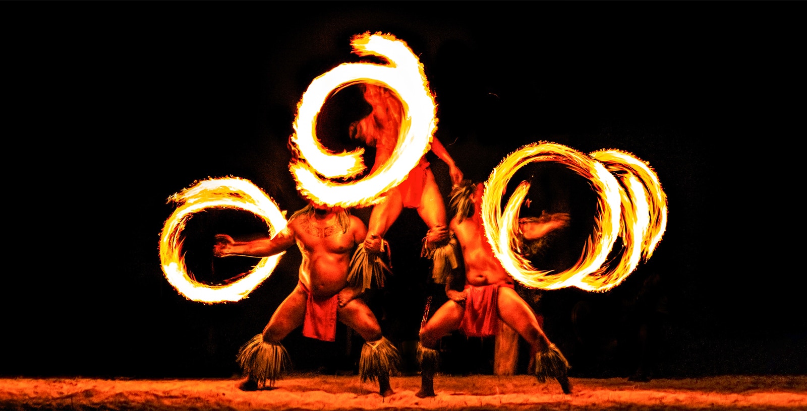 Hawaiian performers with fire rings at a traditional Luau in Honolulu, Hawaii.