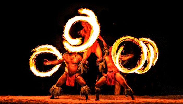 Hawaiian performers with fire rings at a traditional Luau in Honolulu, Hawaii.