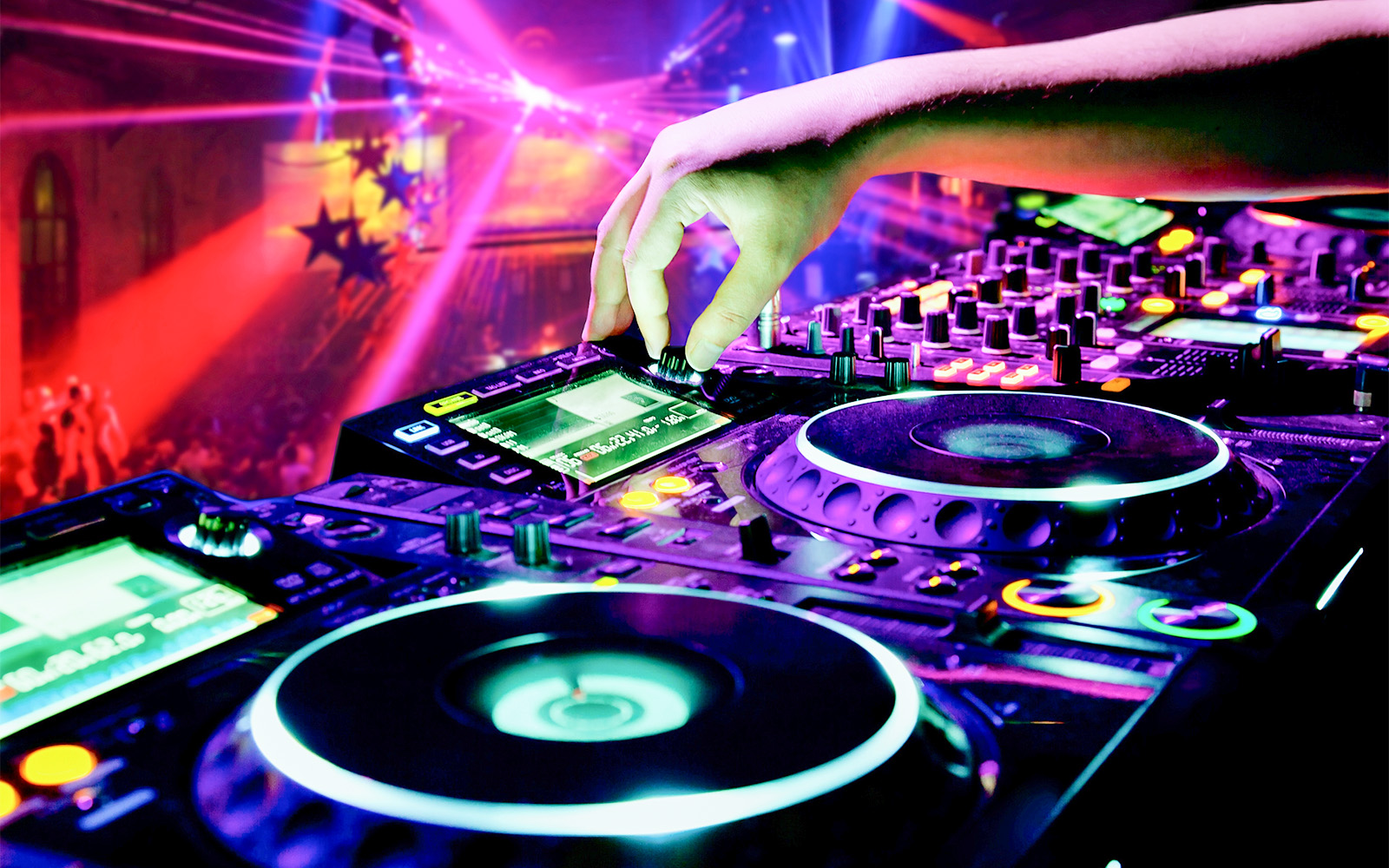DJ mixing music on a cruise during Vivid Sydney festival with colorful lights.