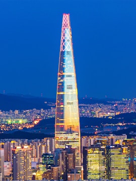Lotte World Tower illuminated at night, view from Seoul Sky Observatory, South Korea.