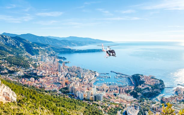 Helicopter flying over Monaco coastline during panoramic tour.