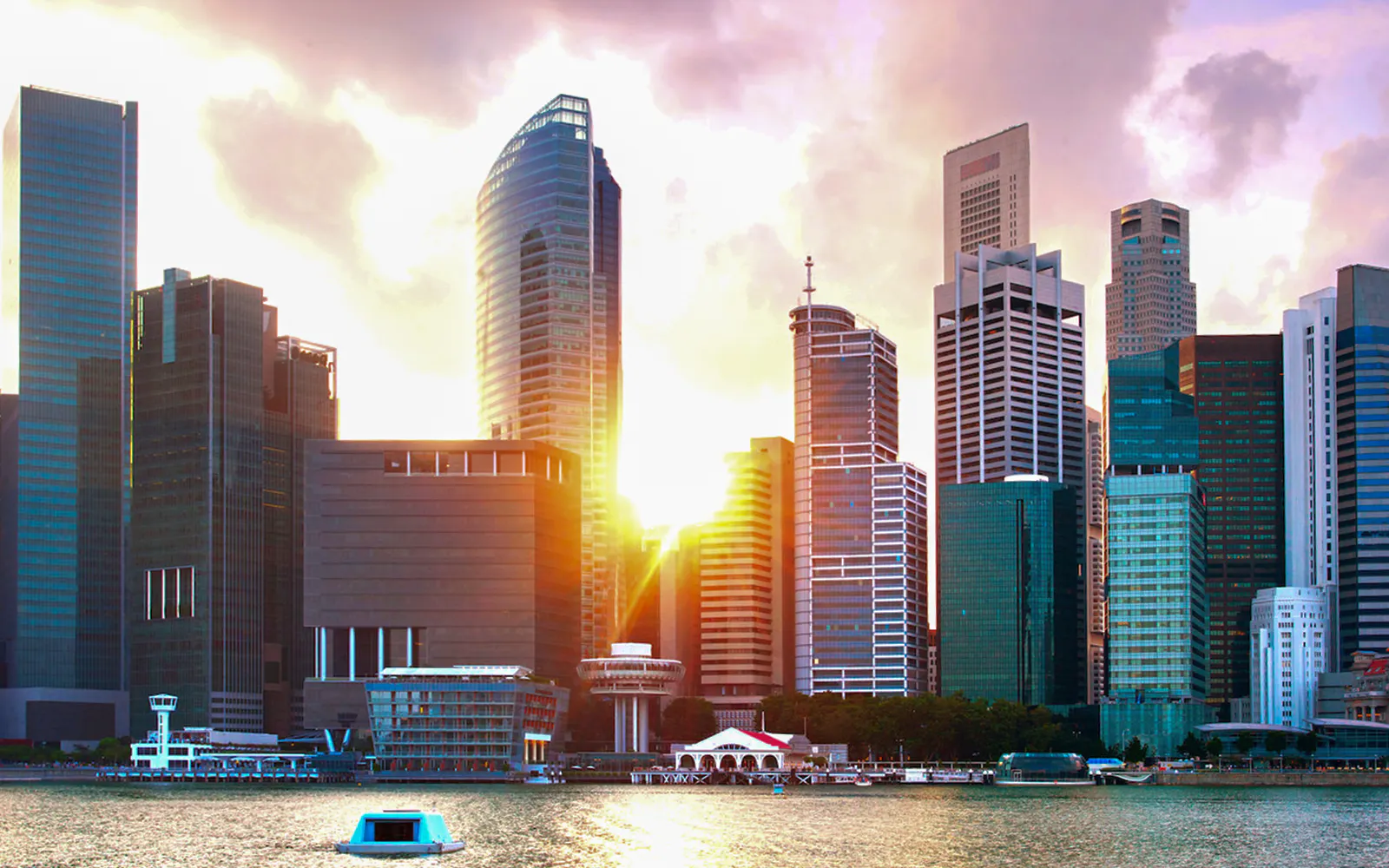 Singapore skyline viewed from a yacht at sunset.