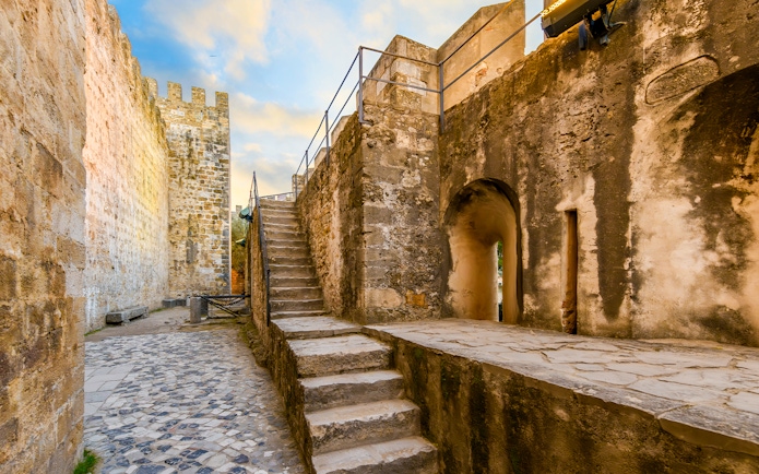 Stone pathway and stairs inside Sao Jorge Castle, Alfama district, Lisbon, Portugal.