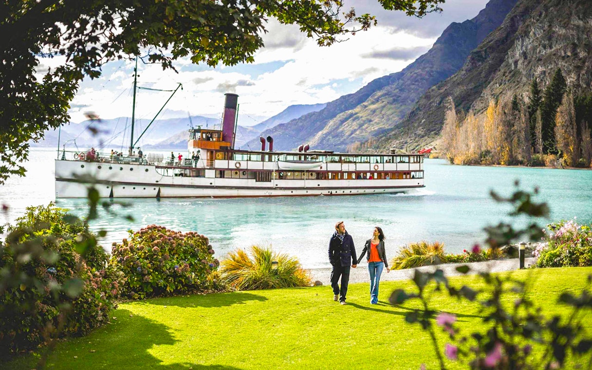 TSS Earnslaw cruising on Lake Wakatipu with mountains in Queenstown, New Zealand.