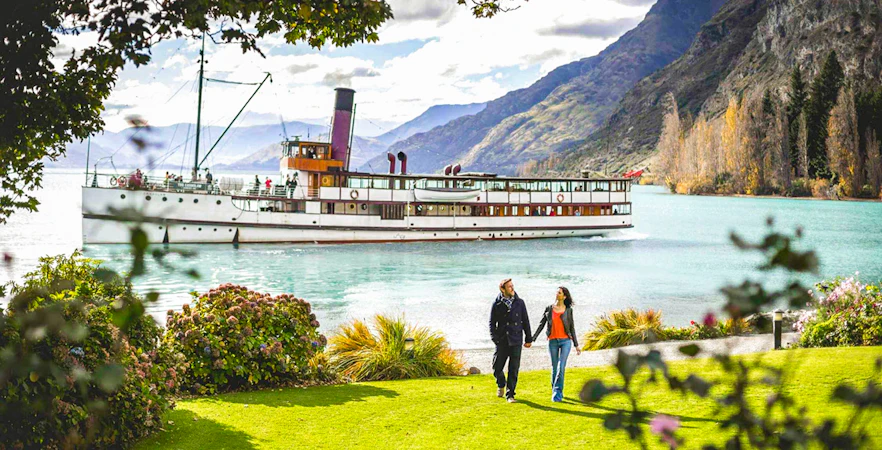 TSS Earnslaw cruising on Lake Wakatipu with mountains in Queenstown, New Zealand.
