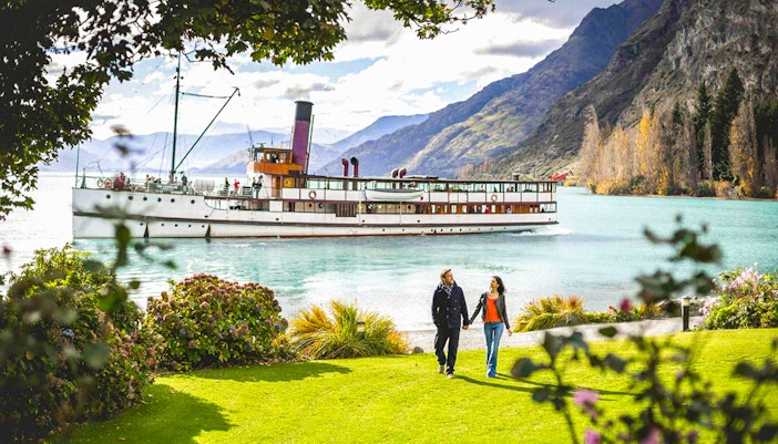 TSS Earnslaw cruising on Lake Wakatipu with mountains in Queenstown, New Zealand.